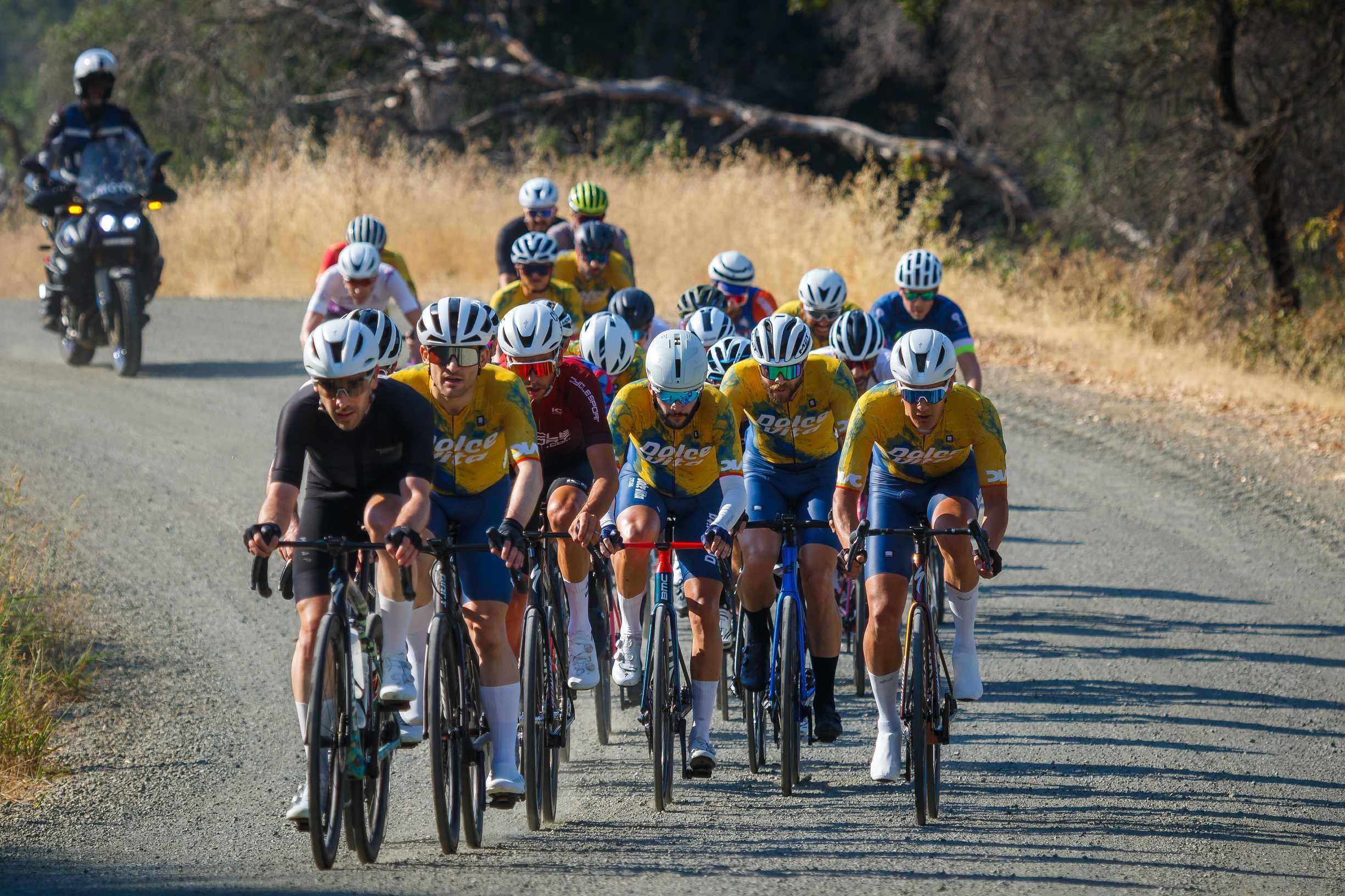 The peloton on the gravel stretch of the Winters course, Dolce Vita riders on the front
